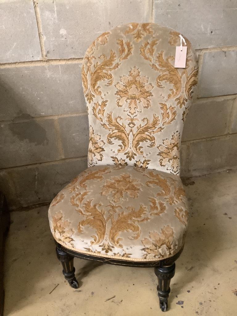 A Victorian ebonised and gilt upholstered nursing chair and pair of balloon back chairs